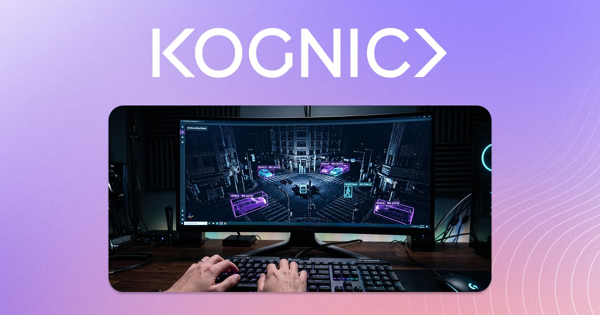 Hands typing at a keyboard beside a monitor showing a 3D point cloud of a city street with highlighted objects and annotation bounding boxes.